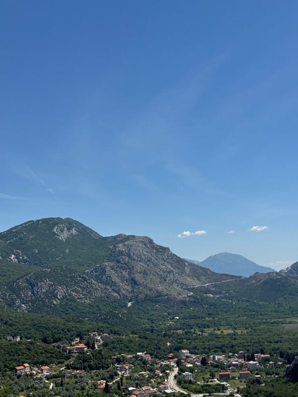 Tourist documents scenic coastal views in Montenegro resort town