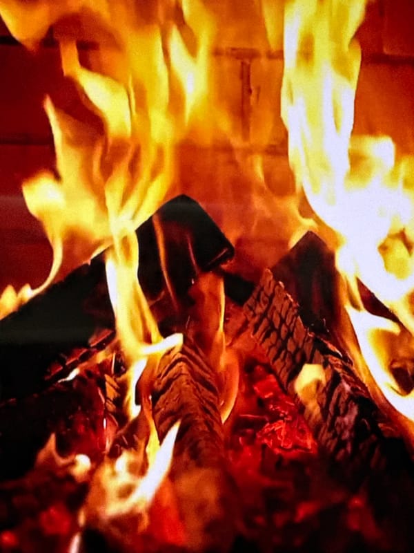 Close-up of a roaring fireplace, logs fully ablaze