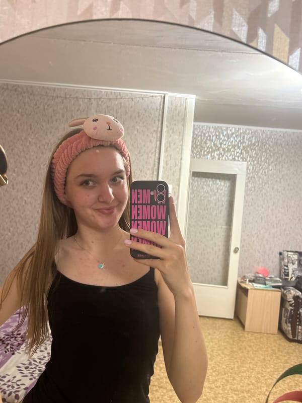 Woman documents evening selfie session with cat in Perm apartment