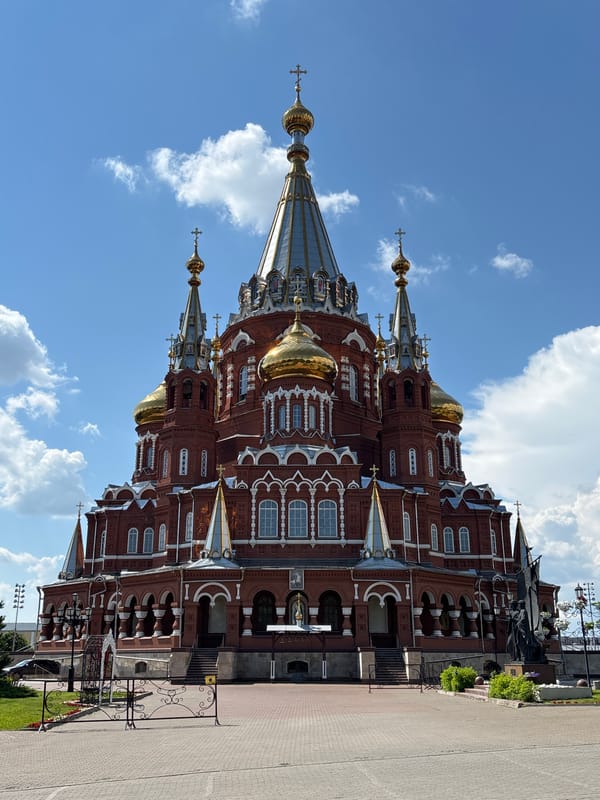 Boy enjoys VR simulator and rides near Izhevsk cathedral