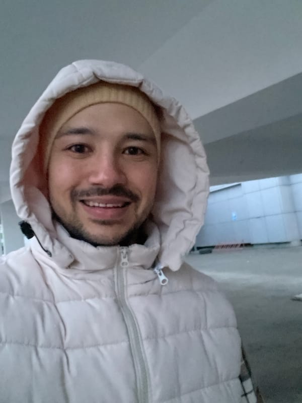 Man photographed smiling in Izhevsk building corridor