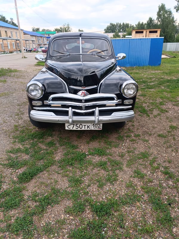 Vintage car and blooming garden in Tolbazy, Russia