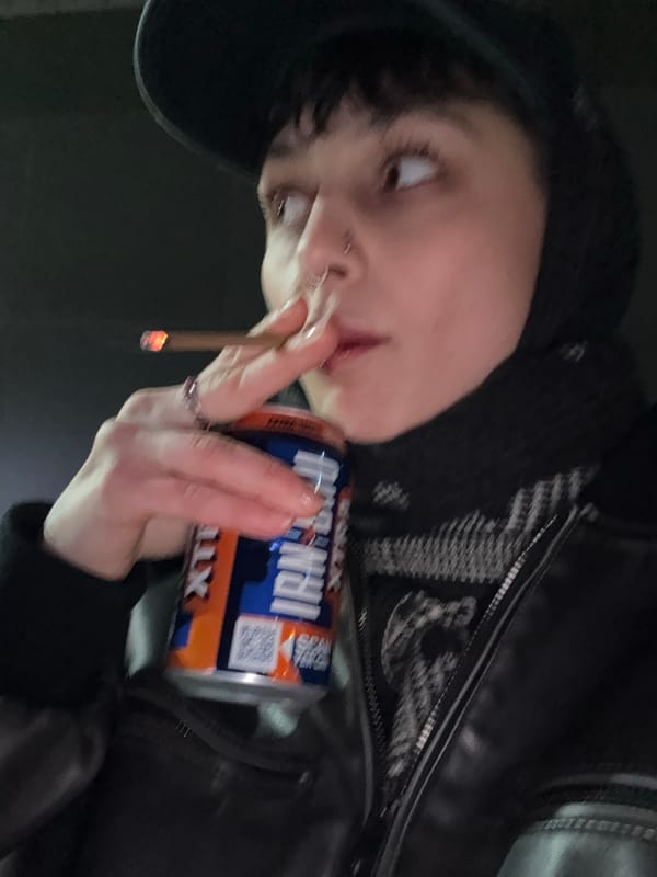 Person smoking cigarettes near overflowing ashtray in Moscow