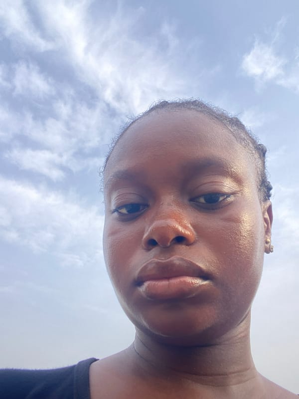 Person photographed from below against cloudy morning sky