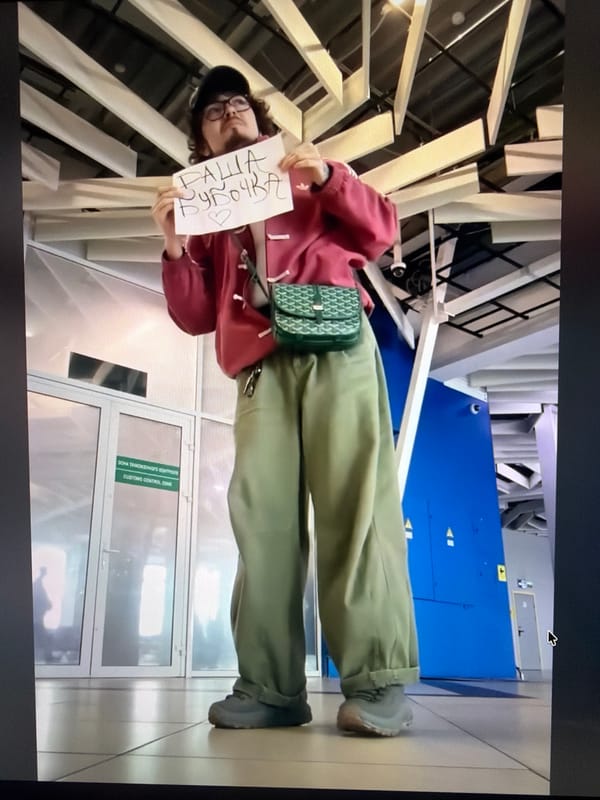 Handwritten note held up inside a Cyprus community space
