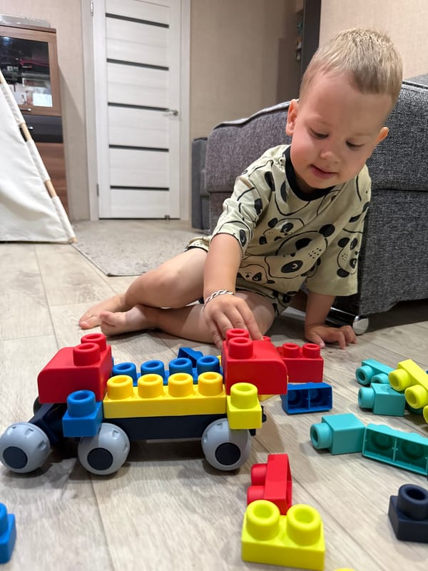 Toddler playtime with blocks and toys at a Rusanovo home