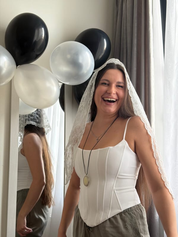Woman celebrates in white veil indoors in Belgrade