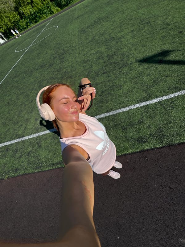 Woman takes playful selfie on sports field in Chaikovsky