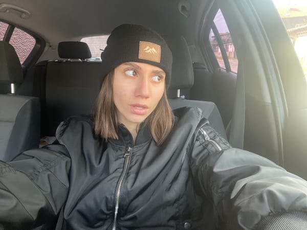 Woman in black jacket observed in car backseat, Sofia