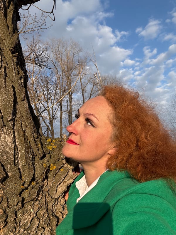 Woman with rainbow umbrella, Boxer dog enjoy spring outing in Russian park