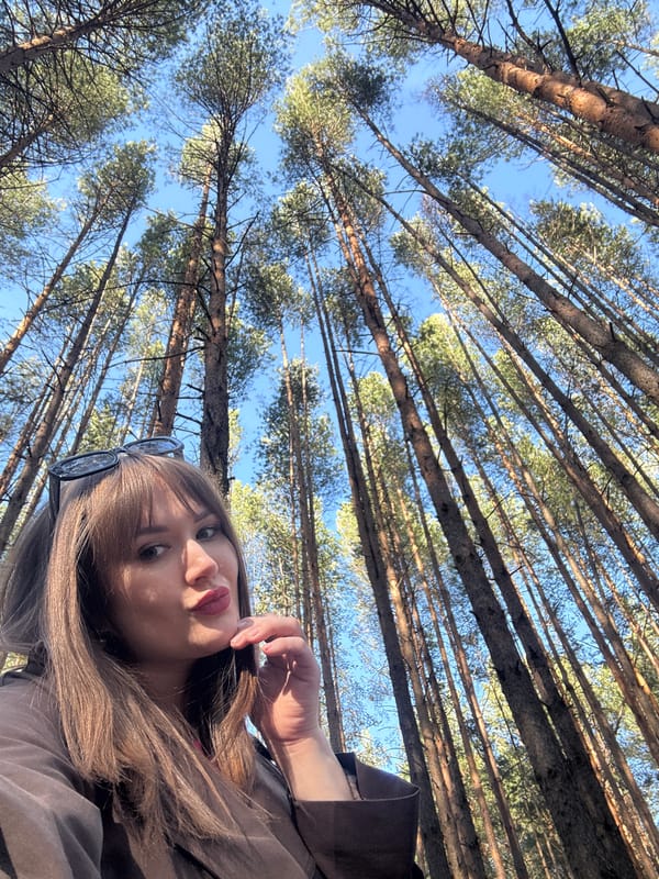Woman takes selfies in pine forest near Chaikovsky, Russia