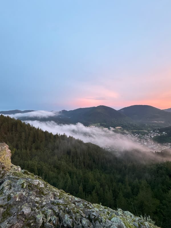 Sunset over Smolyan valley, framed by a hilltop metal cross