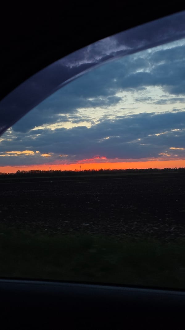 Dramatic sunset observed over rural Kavarna landscape from vehicle