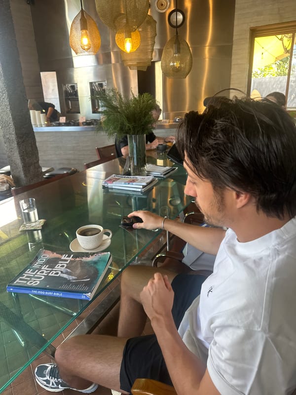 Cafe table session with vinyl, surf books, and a smoothie