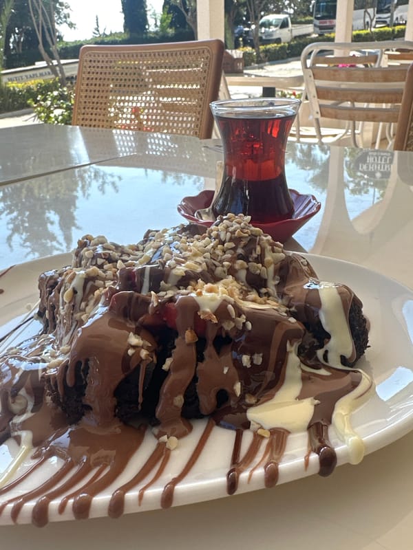 Tourist captures dessert and harbor views in Kaş, Turkey
