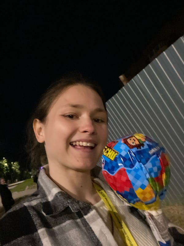Woman poses with cartoon balloon in Peresvet, Russia