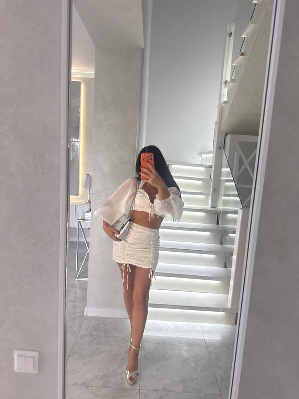Mirror selfies showcasing a white ruched two-piece outfit in Malinovka