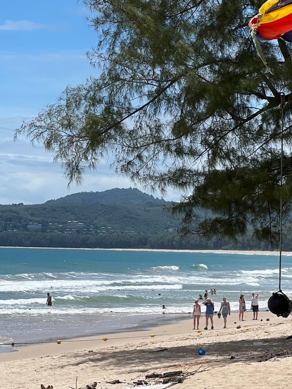 A tropical beach morning with warning flags and changing skies