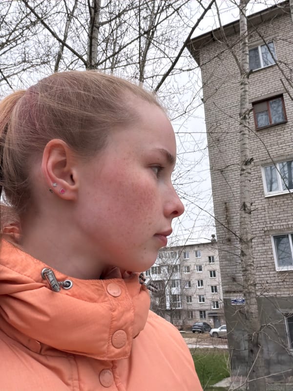 Young blonde person photographed looking skyward in Berezniki