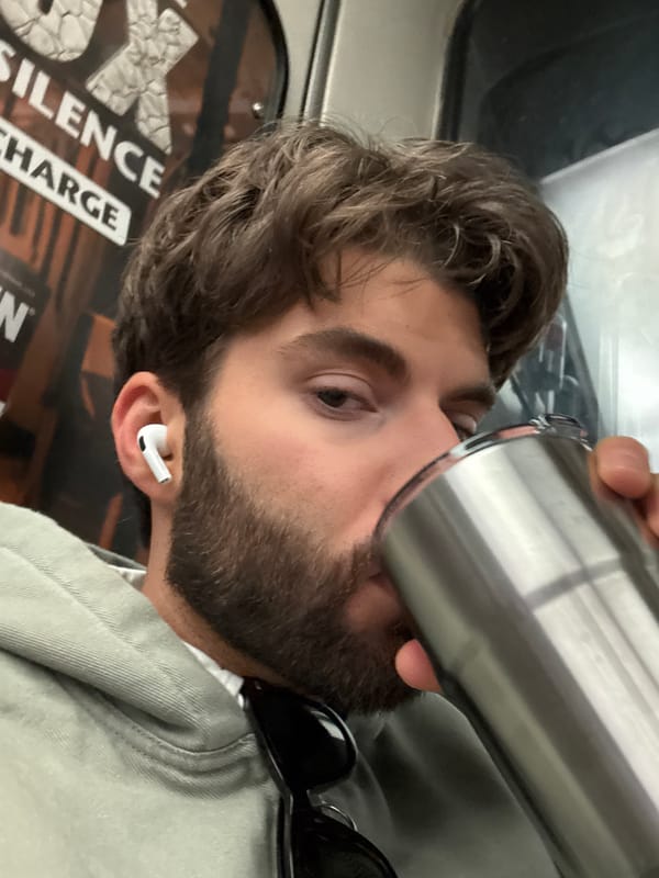 Man drinks from travel mug on Montreal public transit