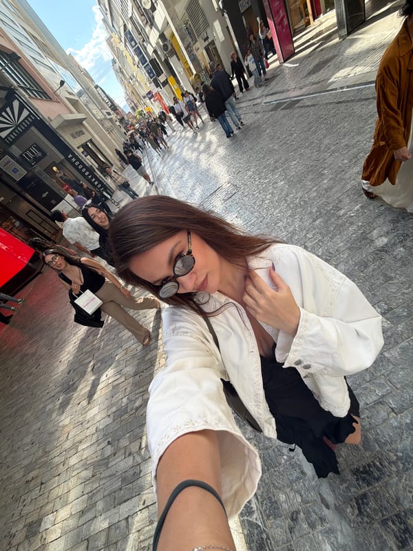 Tourist documents midday stroll through Athens shopping district