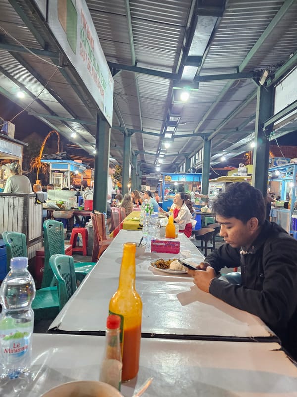 Late-night street food stall scene in Denpasar, Indonesia