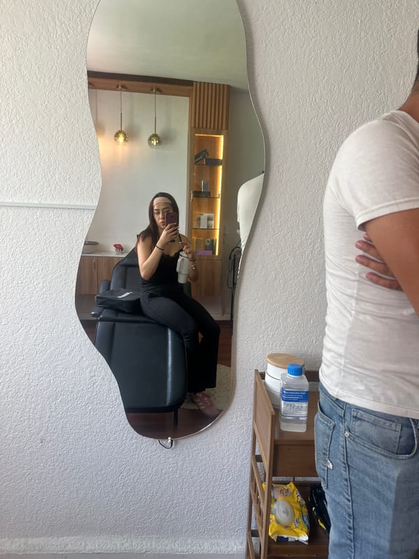 Woman takes mirror selfie during filming session in Puebla