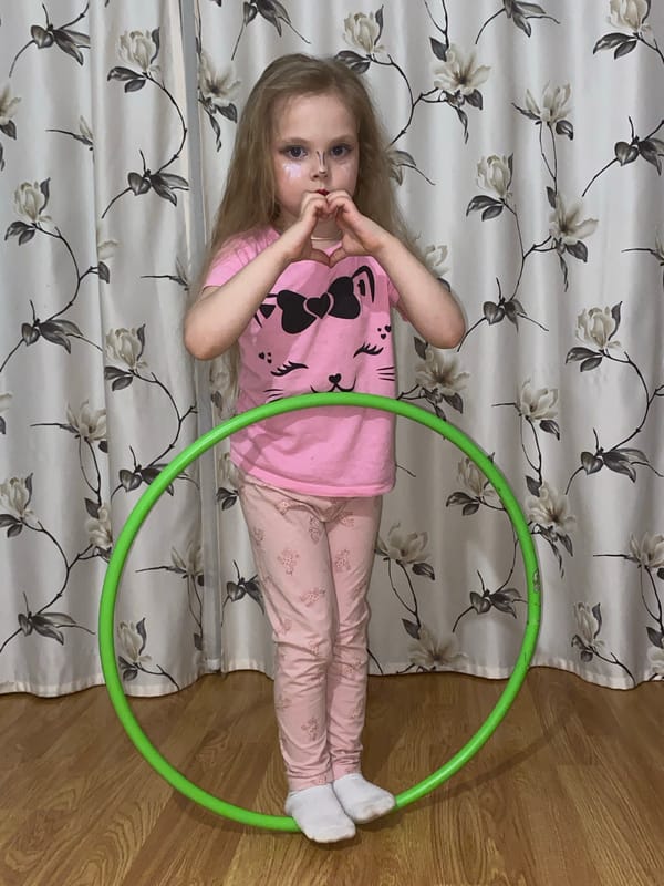 Child plays with hula hoop indoors in Votkinsk
