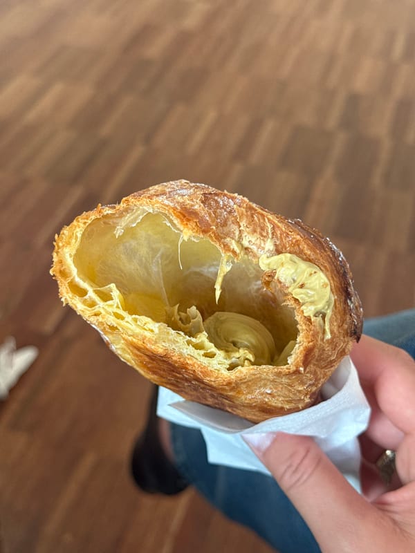 Person enjoys filled croissant in early morning Orio al Serio