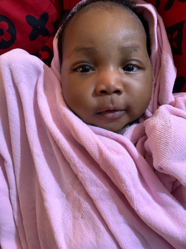 Baby in pink blanket observed in Rafin Bauna, Nigeria