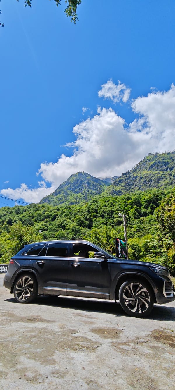 SUV parked roadside amid mountain scenery in Bzypta, Abkhazia