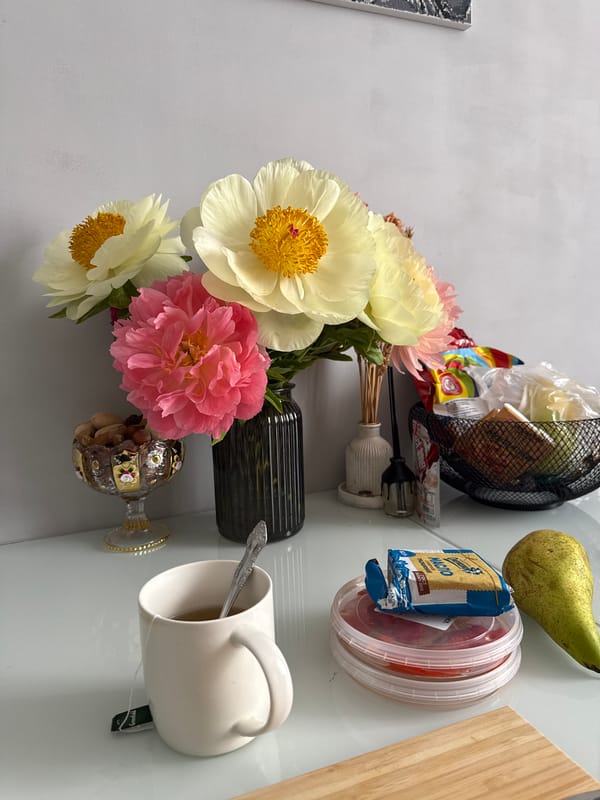 Peony bouquet arranged in still life display near window