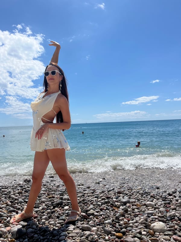 Woman poses for photos at Montenegro beach during summer afternoon
