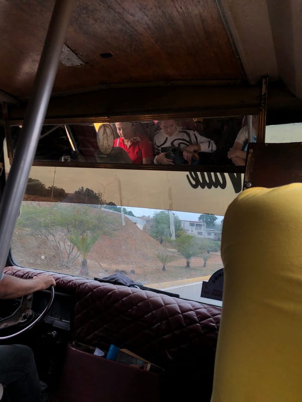 Vehicle journey through Venezuelan towns captures stadium, tropical scenery