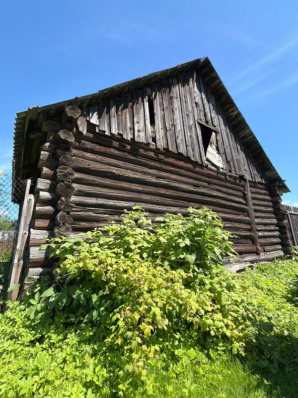 Weathered cabin, cozy caravan interior, and owl figurine in rural Russia