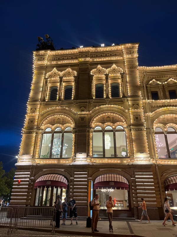 GUM department store glowing under warm lights at night