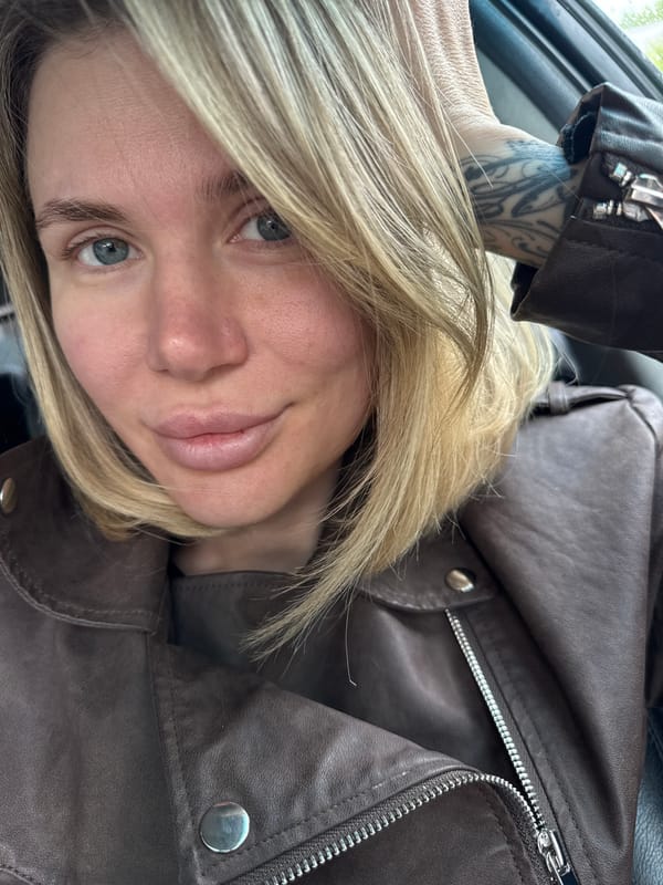 Blonde woman in leather jacket observed indoors in Gorno-Altaysk
