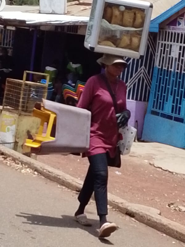 Man leads bull while cycling through Tamale streets
