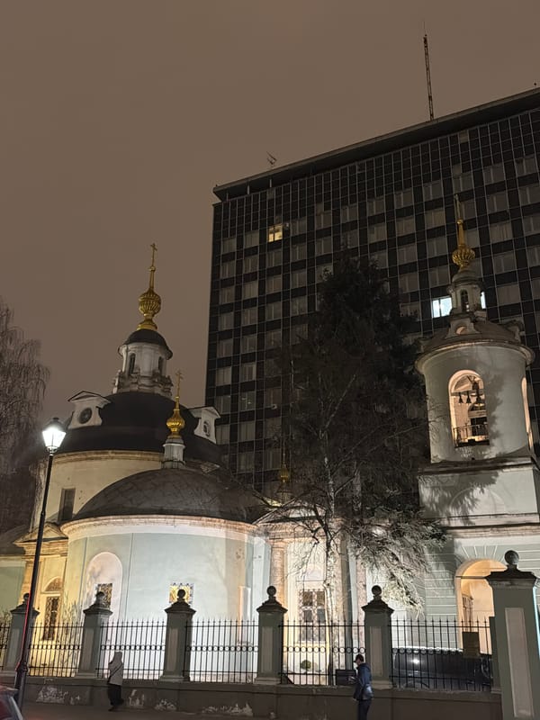 Street musician performs acoustic guitar on Moscow sidewalk