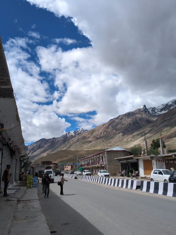 Padum street scene with dramatic Himalayan peaks behind