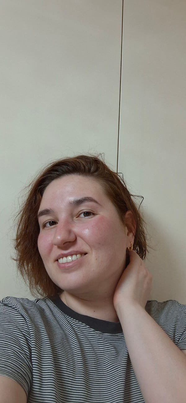 Woman takes selfies with decorative items at Chaikovsky home