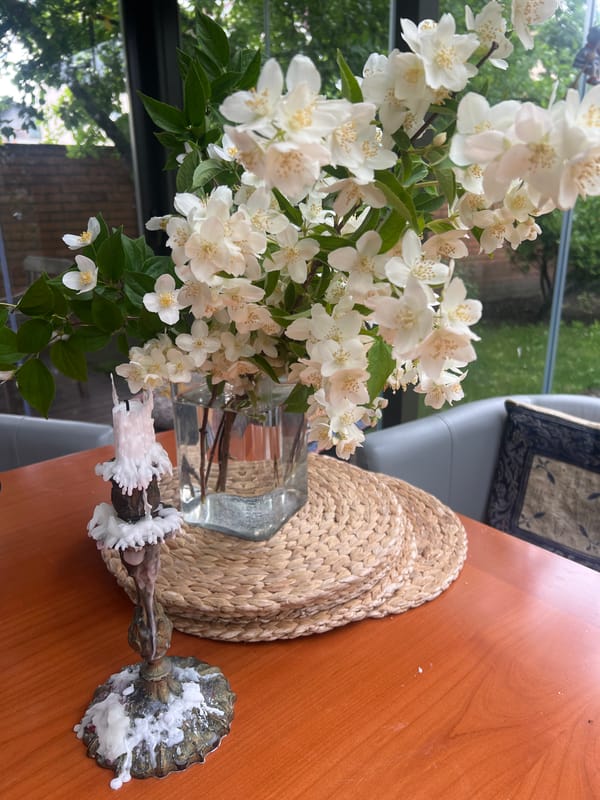 Fresh flowers and a hanging toy decorate a Minsk home interior