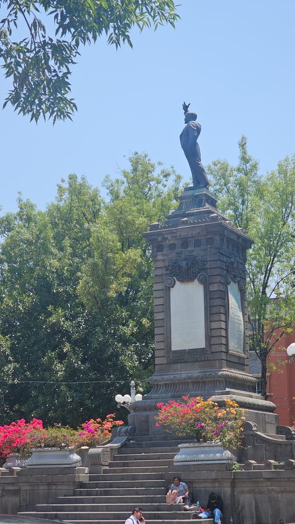 Everyday activity documented around historical monument in Puebla plaza