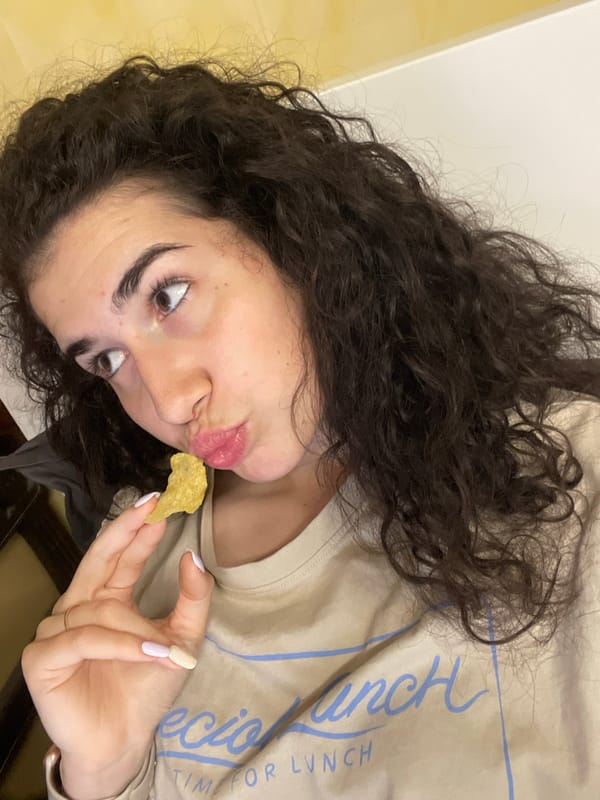 Evening routine: woman snacking, feeding excited poodle in Sofia