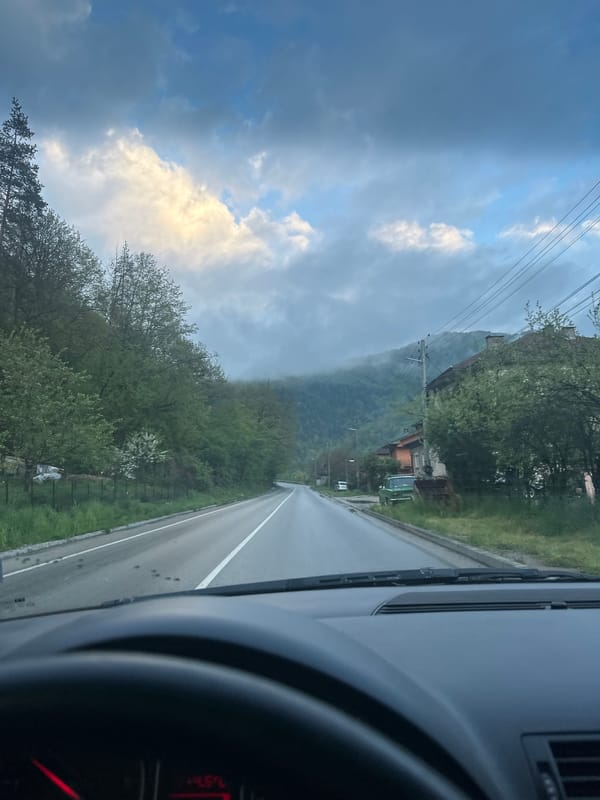 Vehicle travels mountain road near Troyan, Bulgaria