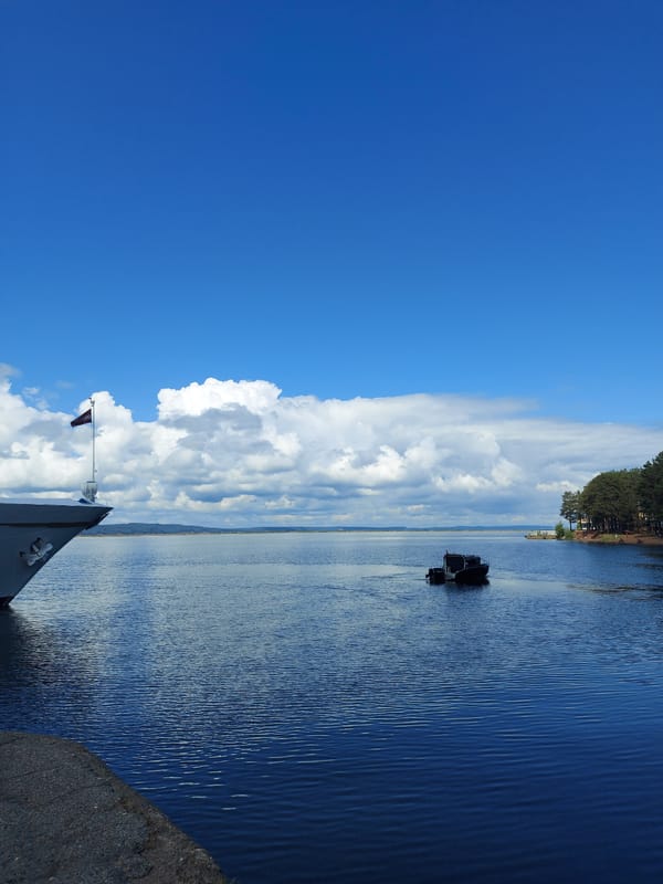 Tourist documents river cruise ships and waterfront in Chaikovsky, Russia
