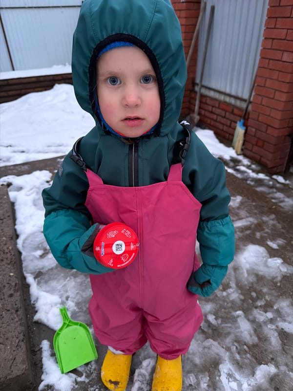 Child plays with Baby Yoda toy during mealtime in Chaikovsky