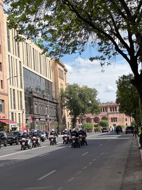 Police motorcade escorts official vehicles through central Yerevan streets