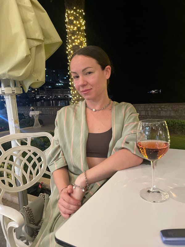 Woman dines outdoors at night in Rafailovići, Montenegro