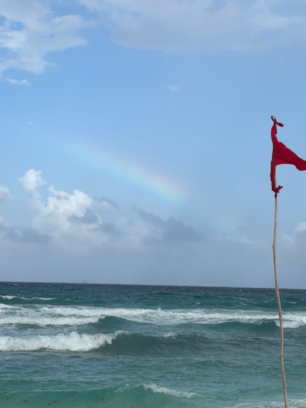 Red warning flag spotted on Cancún beach amid rainbow